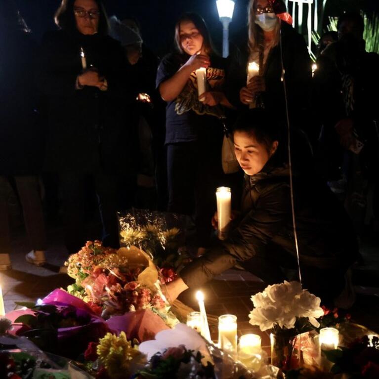 People mourn with candles for victims of a mass shooting in front of the city hall of Monterey Park, California, the United States, on Jan. 23, 2023.