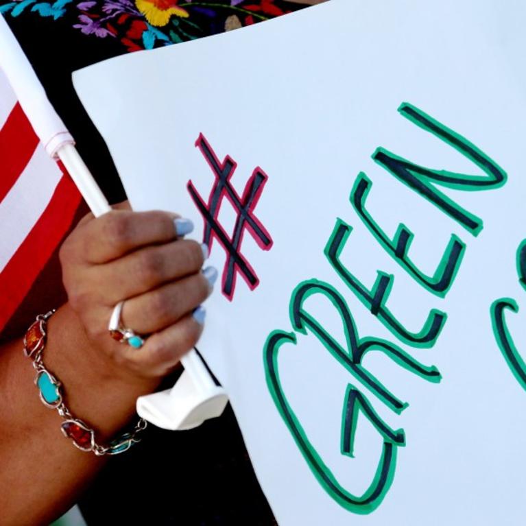 A demonstrator at a protest for immigration reform in downtown Los Angeles on Aug. 26, 2020. (Los Angeles Times)