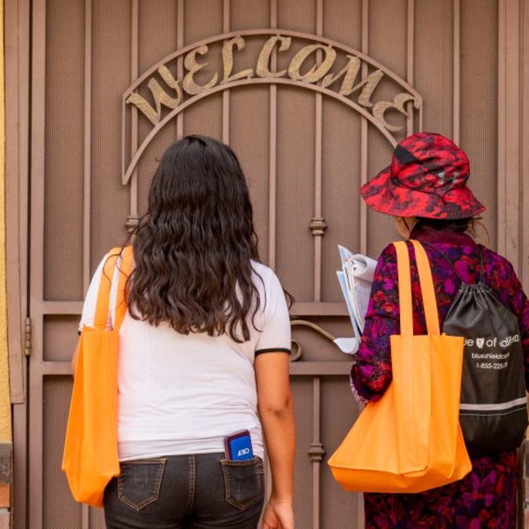 Census workers and local nonprofits are pivoting and scrambling to use phone banks, texting and online tools to fill gaps in outreach efforts. Above, Wendy Barillas, left, and community census educator Lazara Bustos with the nonprofit Give for a Smile wait for a resident to answer the door in Anaheim on Wednesday, March 11, 2020 as part of a door-to-door effort to encourage residents to participate in the census. (Photo by Leonard Ortiz, Orange County Register/SCNG)