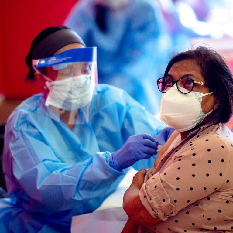 Farida Uddin, a 65-year-old Corona resident, receives a dose of the Moderna COVID-19 vaccine inside the Corona High School gymnasium Thursday, Jan. 14, 2021, as shots expand to those 65 and older in Riverside County. (Photo by Watchara Phomicinda, The Press-Enterprise/SCNG)