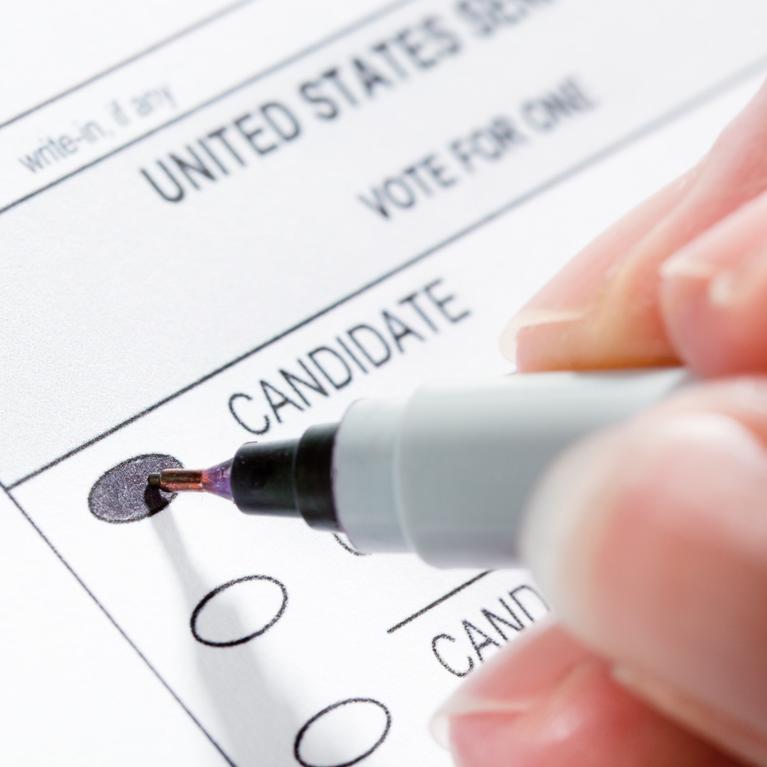 Image via iStock of someone filling out a ballot
