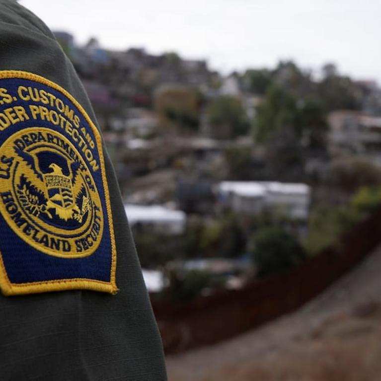 A U.S. Border Patrol agent looks out over Tijuana, Mexico from the U.S.-Mexico border wall in San Diego on Feb. 2. (Mike Blake/Reuters)