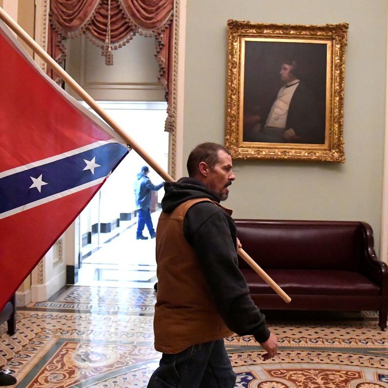 A protester who gained entry to the Capitol carried a Confederate flag