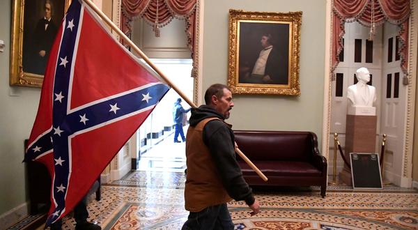 A protester who gained entry to the Capitol carried a Confederate flag