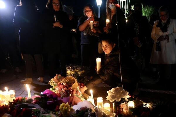 People mourn with candles for victims of a mass shooting in front of the city hall of Monterey Park, California, the United States, on Jan. 23, 2023.