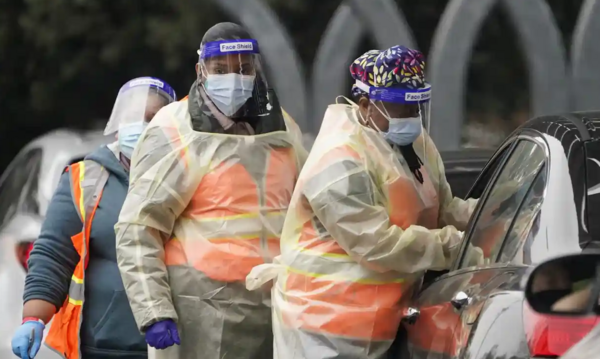 Workers administer a Covid-19 vaccine at a Los Angeles county site at California State University Northridge on Tuesday. Photograph: Marcio José Sánchez/AP