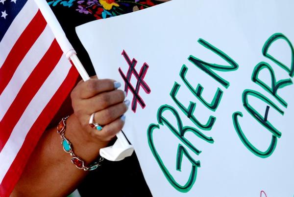 A demonstrator at a protest for immigration reform in downtown Los Angeles on Aug. 26, 2020. (Los Angeles Times)