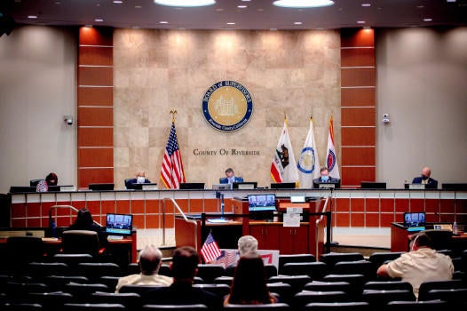 Supervisors, wearing protective face masks as a precaution against the spread of the new coronavirus, listen to public comment via telephone during the Riverside County Board of Supervisors meeting to decide whether to lift coronavirus health orders in Riverside on Tuesday, May 5, 2020. (Photo by Watchara Phomicinda, The Press-Enterprise/SCNG)