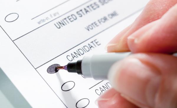 Image via iStock of someone filling out a ballot