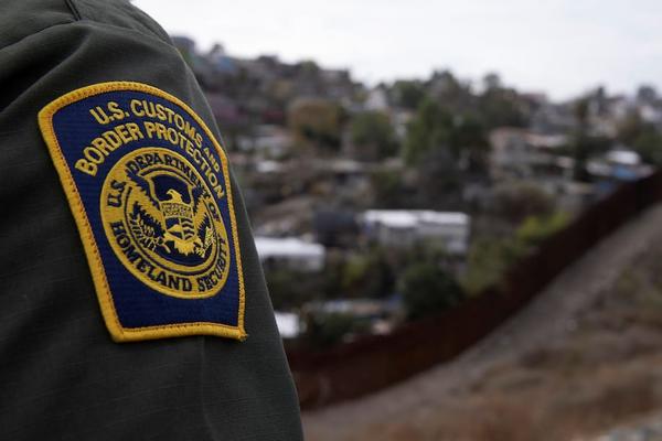 A U.S. Border Patrol agent looks out over Tijuana, Mexico from the U.S.-Mexico border wall in San Diego on Feb. 2. (Mike Blake/Reuters)