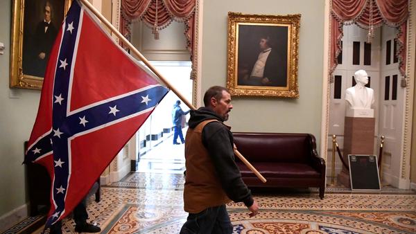A protester who gained entry to the Capitol carried a Confederate flag