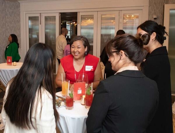 Margaret Huang, president and CEO of the Southern Poverty Law Center, talks with members of the Asian American Journalists Association (AAJA) during a social gathering June 28, 2022, in Washington, D.C.